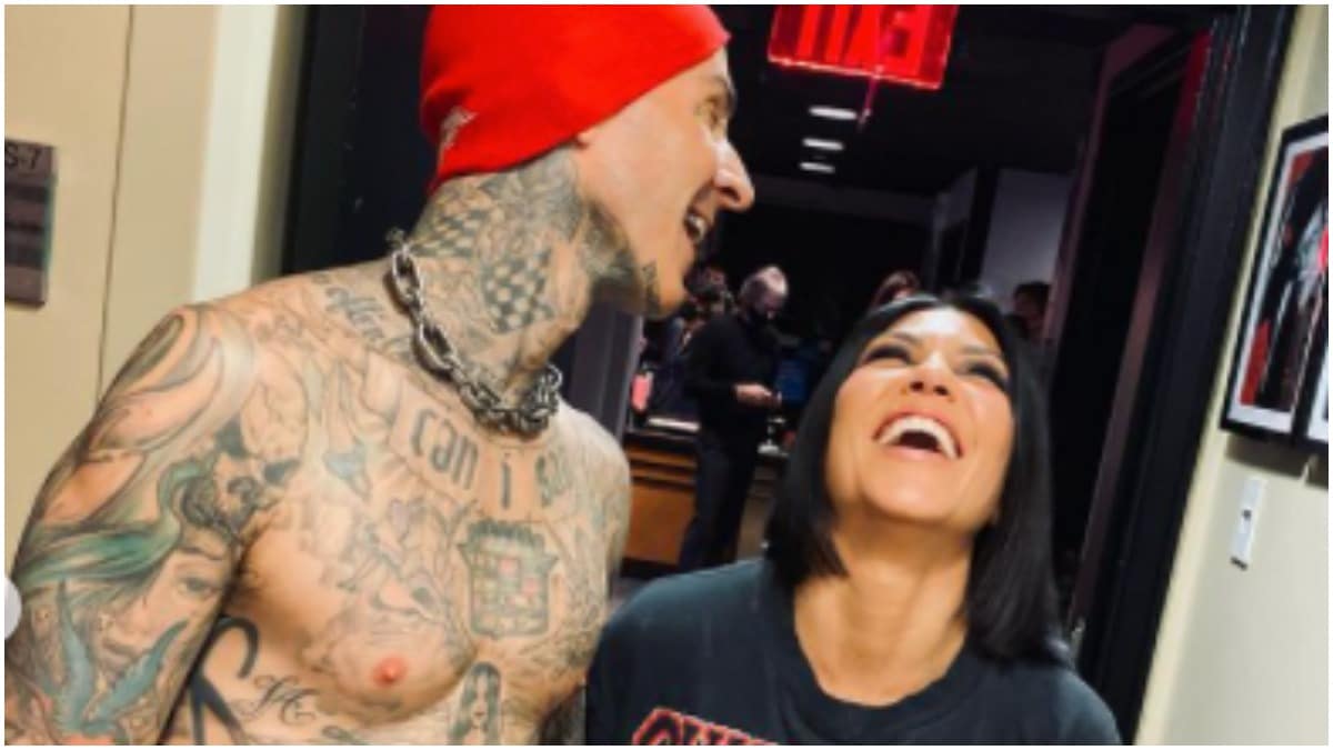 Travis Barker and Kourtney Kardashian smiling and laughing in an Instagram photo.