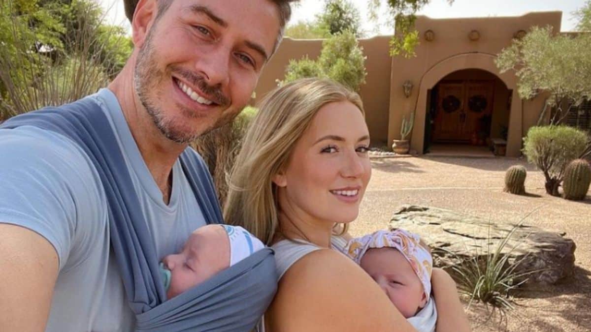 Arie Luyendyk Jr. and Lauren Burnham smiling with their twins in wraps