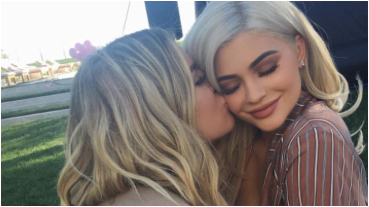 Khloe Kardashian kissing Kylie Jenner on the cheek in an Instagram post.