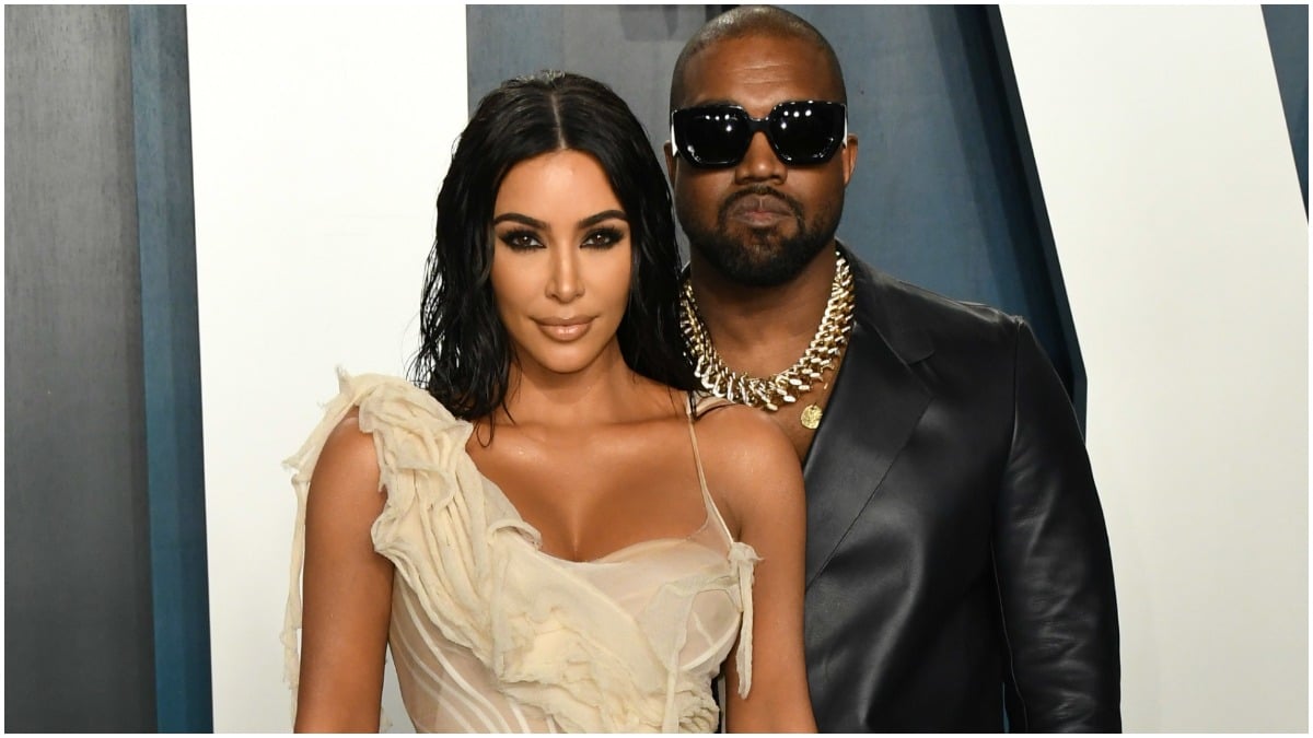 Kim Kardashian and Kanye West posing at the 2020 Vanity Fair Oscars Party.