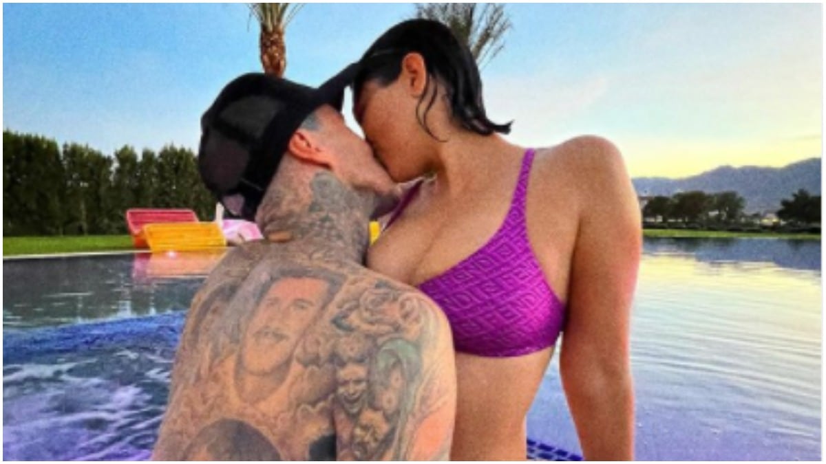 Travis Barker and Kourtney Kardashian kissing in a jacuzzi.