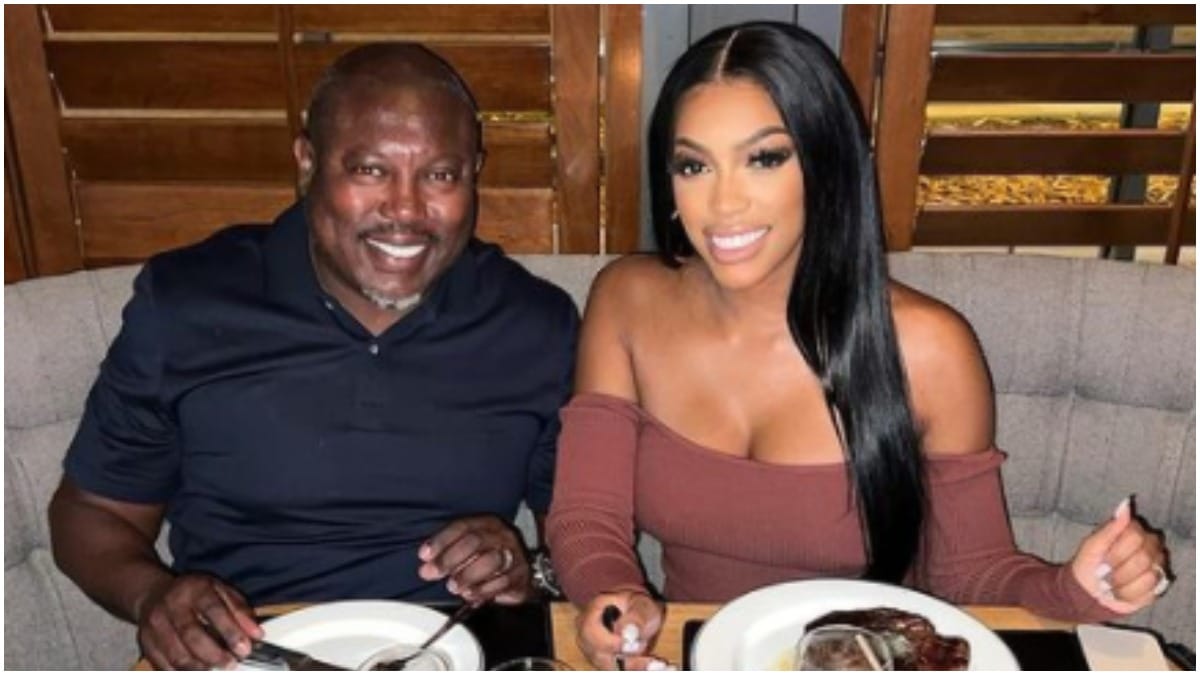 Simon Guobadia and Porsha Williams from Real Housewives of Atlanta smiling at dinner.