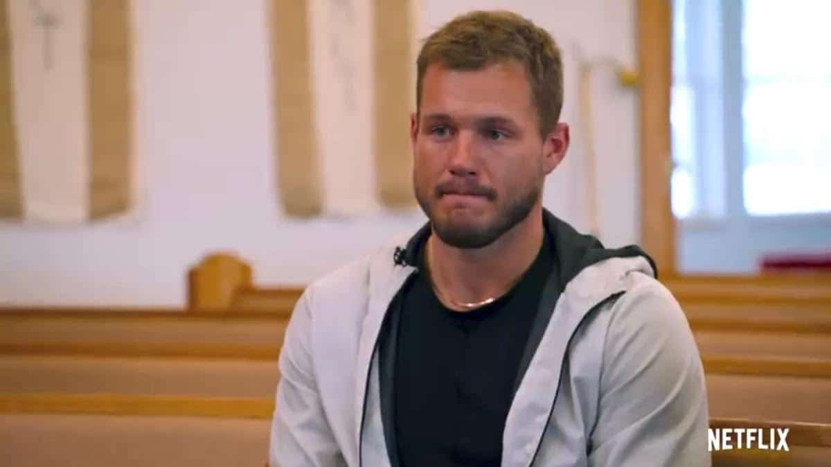 Colton Underwood sits in a pew