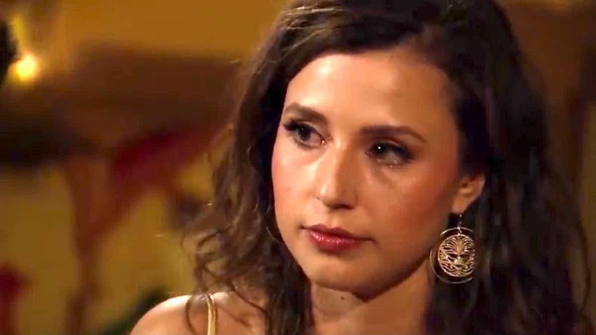 Katie Thurston wears gold earrings