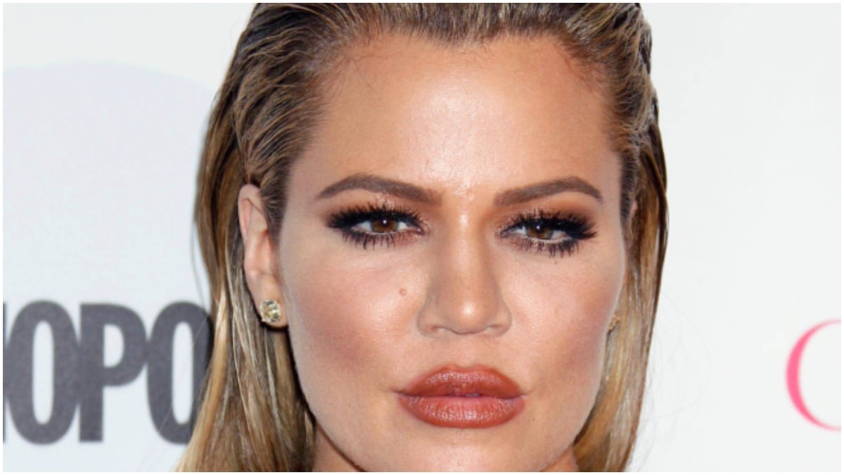 Khloe Kardashian making a stoic face on the red carpet.