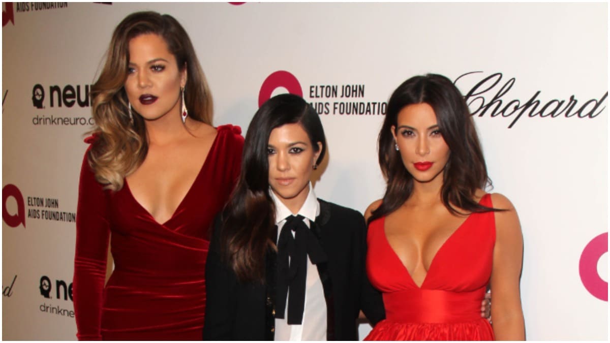 Khloe Kardashian, Kourtney Kardashian, and Kim Kardashian posing together on the red carpet.