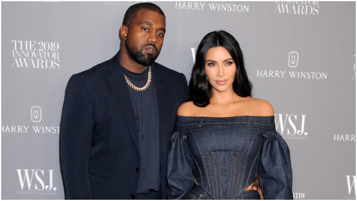 Kim Kardashian and Kanye West posing in denim outfits.