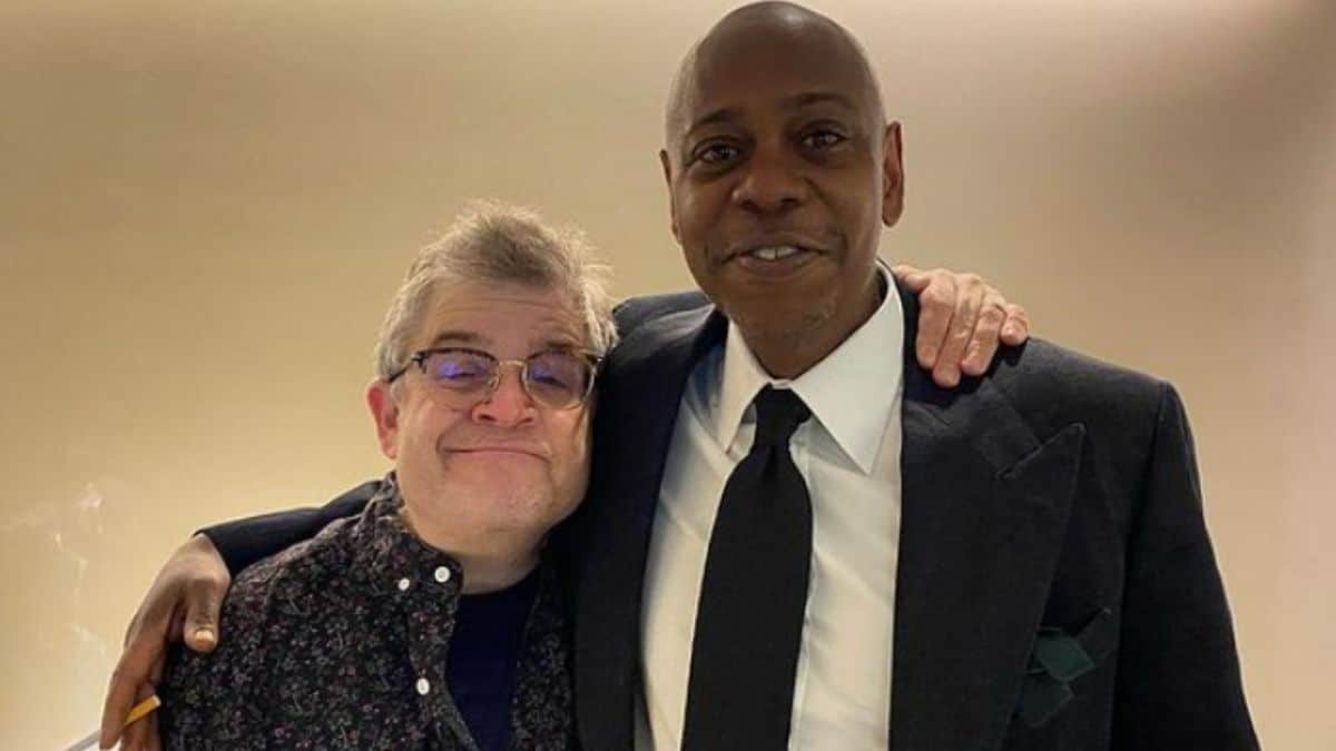 Image of Patton Oswalt and Dave Chappelle embracing