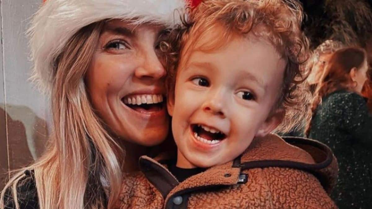 Amanda Kloots with her son in a Christmas hat