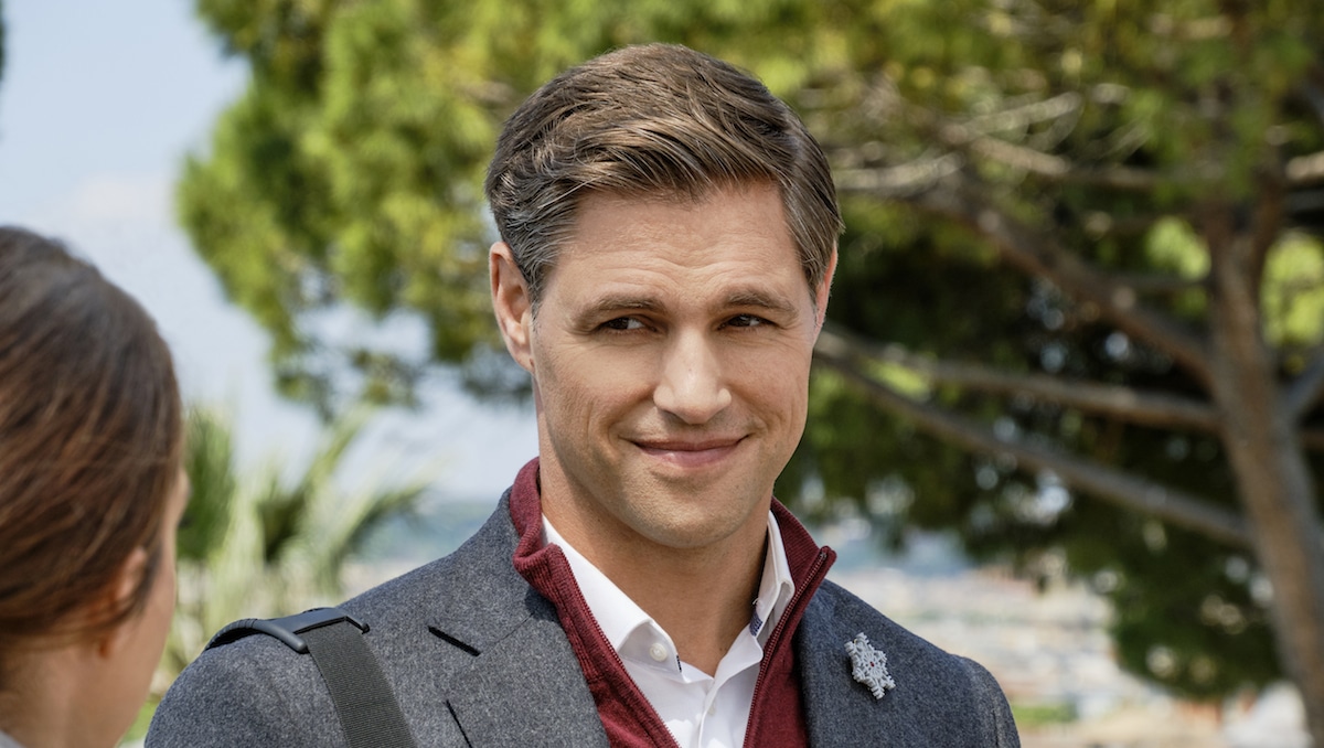 Sam Page in the Hallmark Channel movie Christmas in Rome. The actor starred in an ad for the Kia EV6 in the Super Bowl.