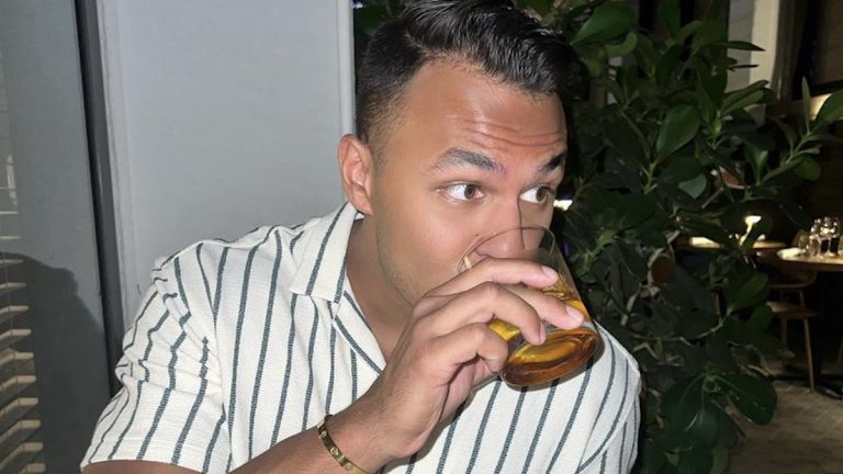 Aaron Clancy drinking a cocktail in Miami