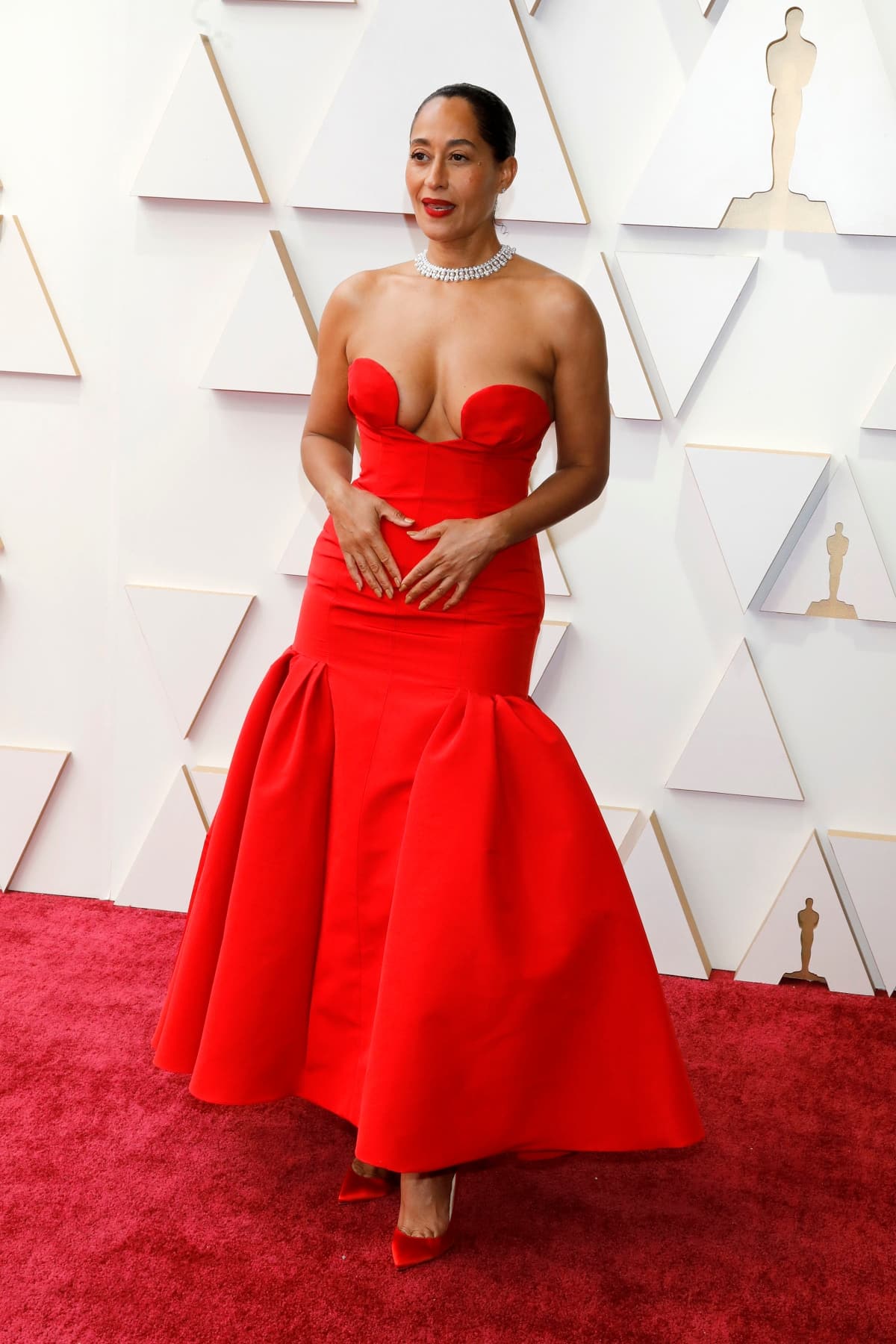 Tracee Ellis Ross on the Oscars 2022 red carpet in a red Carolina Herrera dress