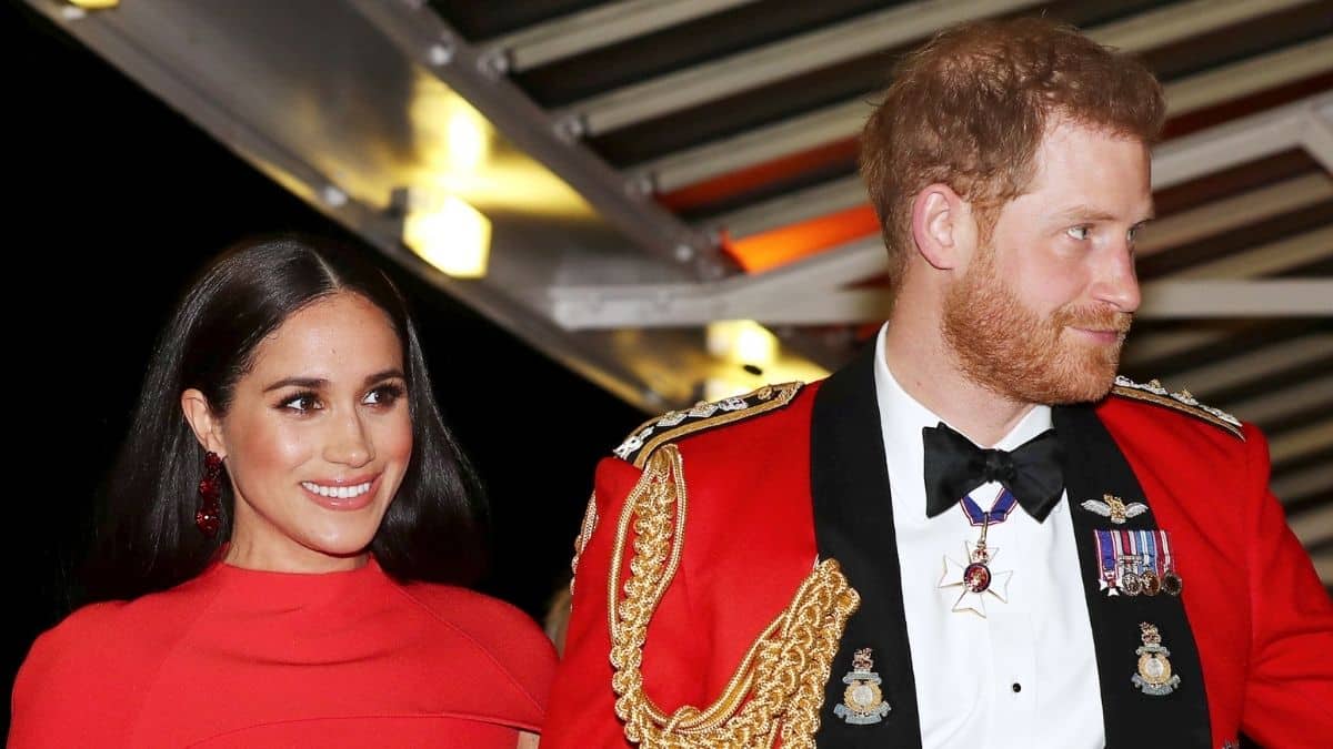 Meghan Markle and Prince Harry in red outfits at an event