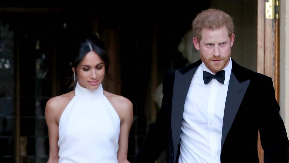 Prince Harry and Meghan Markle in wedding attire going to their reception
