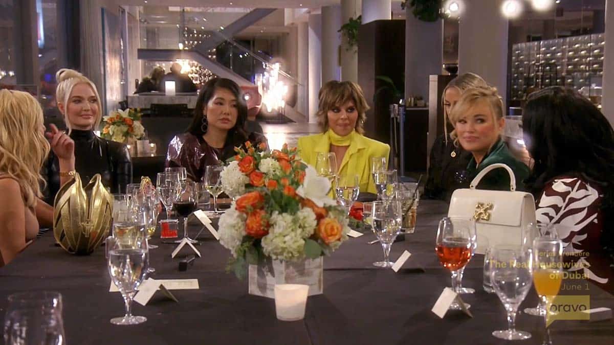 RHOBH Housewives sitting around dinner table at Harry's party  