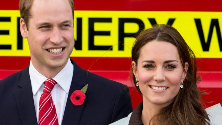 Prince William and Kate Middleton smiling at an event
