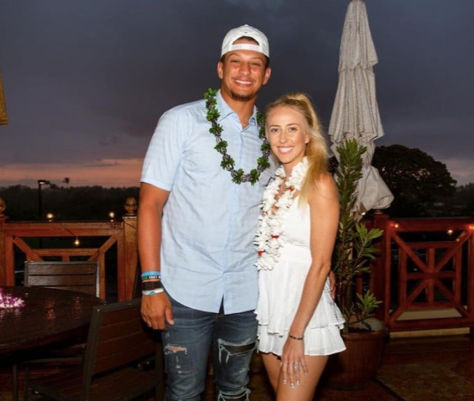 Patrick and Brittany Mahomes pose, Brittany Mahomes in white minidress with small baby bump