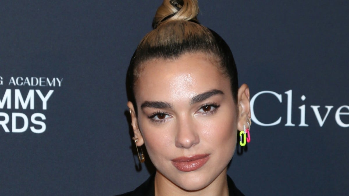 Dua Lipa in bra and tight spandex arches back for headstand splits