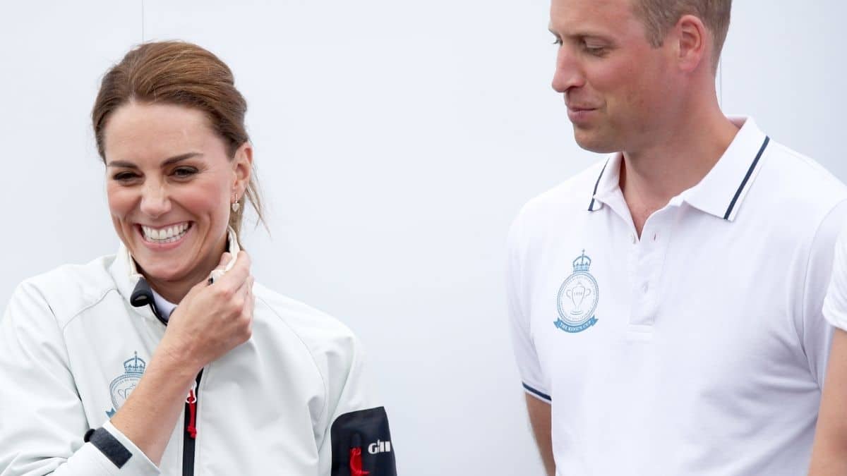 Kate Middleton smiles as Prince William looks on