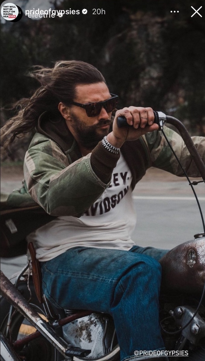 Jason Momoa on a motorcycle to promote his new sunglasses.