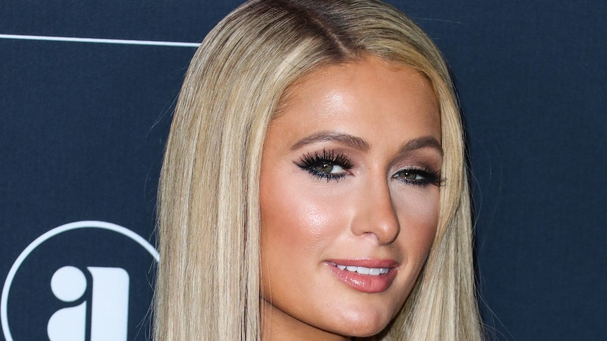 Paris Hilton goes braless in sparkly gown and hugs followers