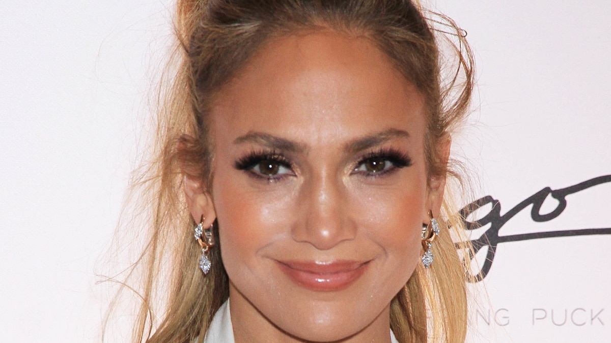 Jennifer Lopez shows off her abs while getting off her private jet.