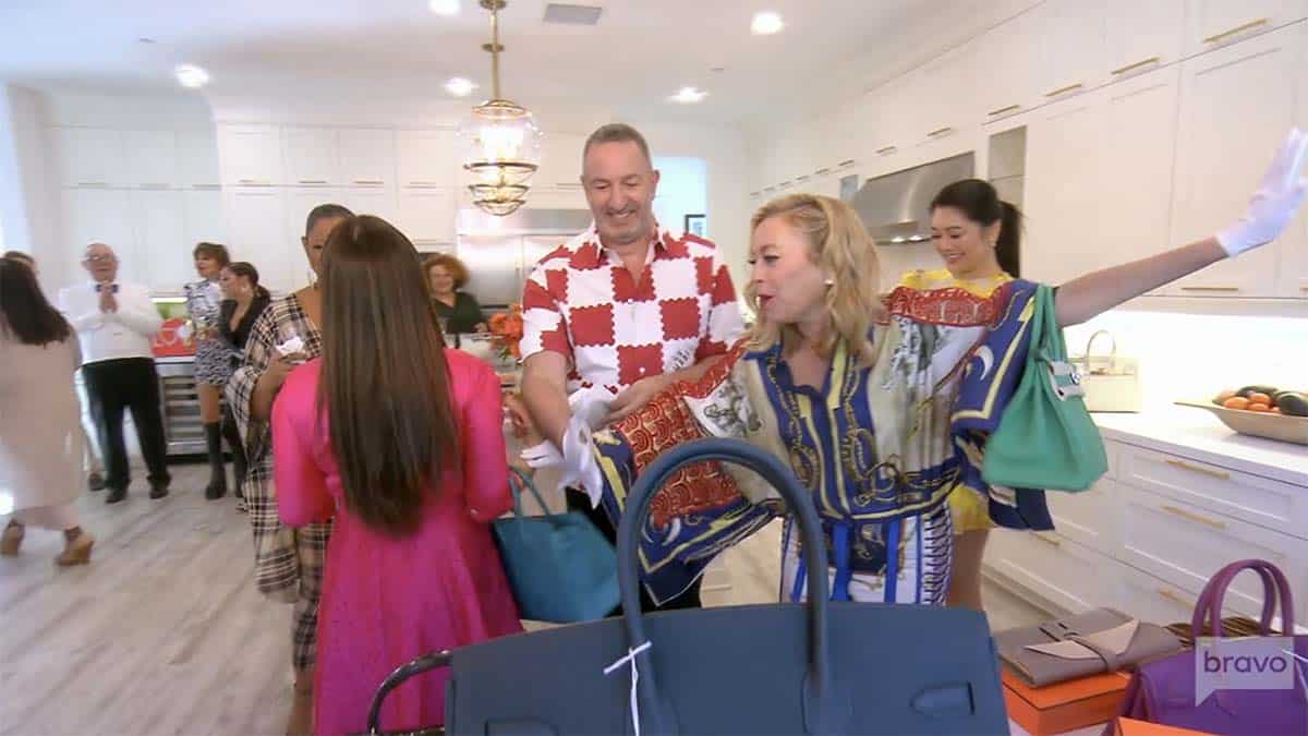 Kyle Richards and Sutton Stracke comically fighting over a Birkin bag 