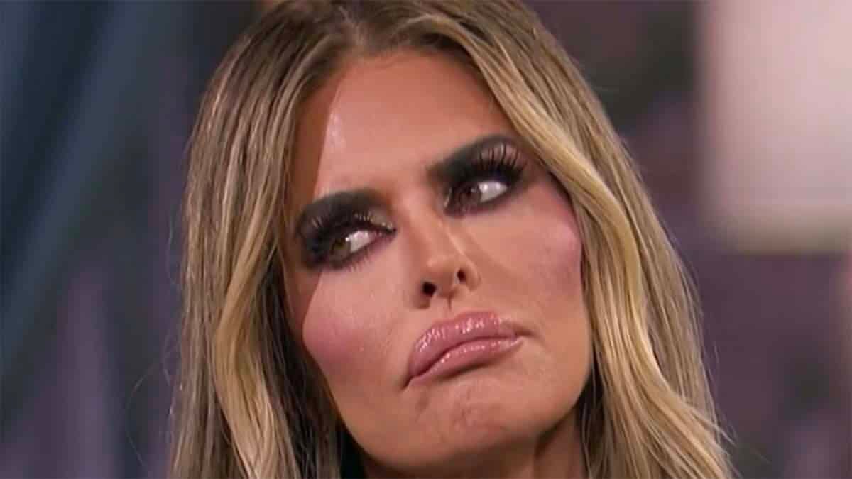 RHOBH's Lisa Rinna with her head cocked to the side, a confused look on her face and lips pouted out.