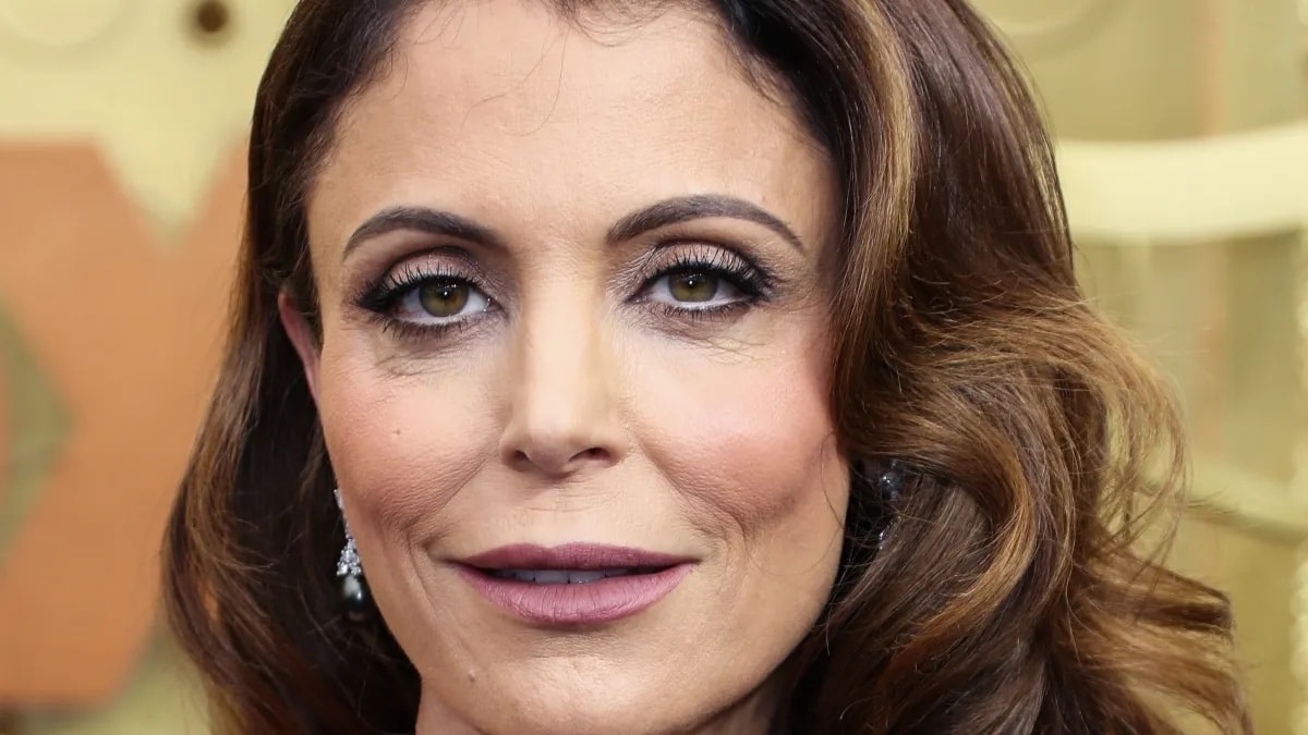 Bethenny Frankel shows off long lashes and purple lipstick.