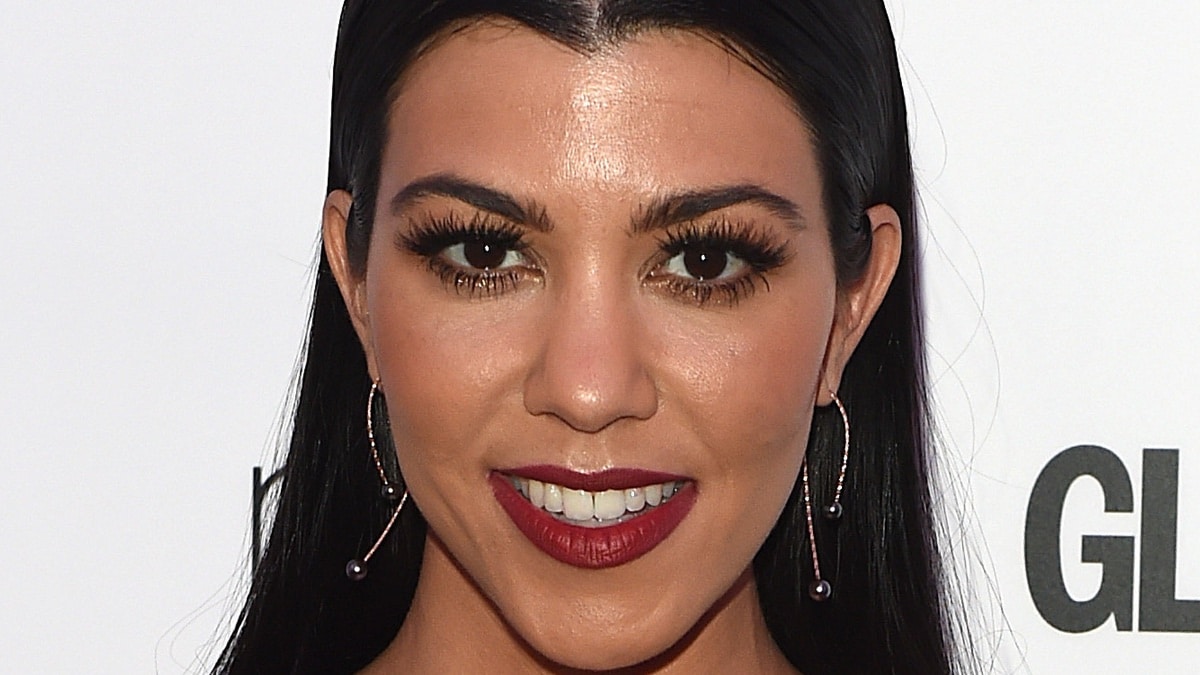 Kourtney Kardashian shows off a big smile on the red carpet.