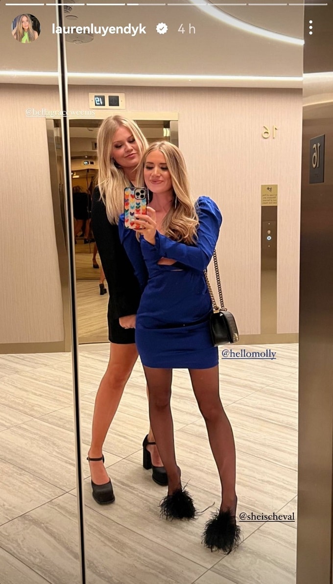 Lauren Luyendyk posing with a friend in a short blue dress