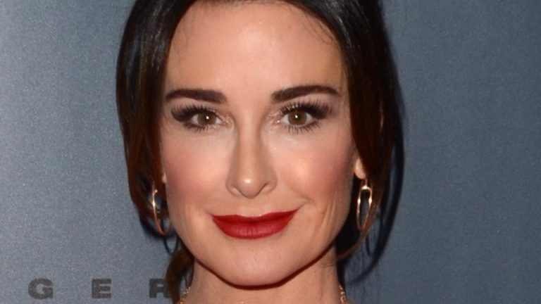 Kyle Richards smiles in red lipstick.