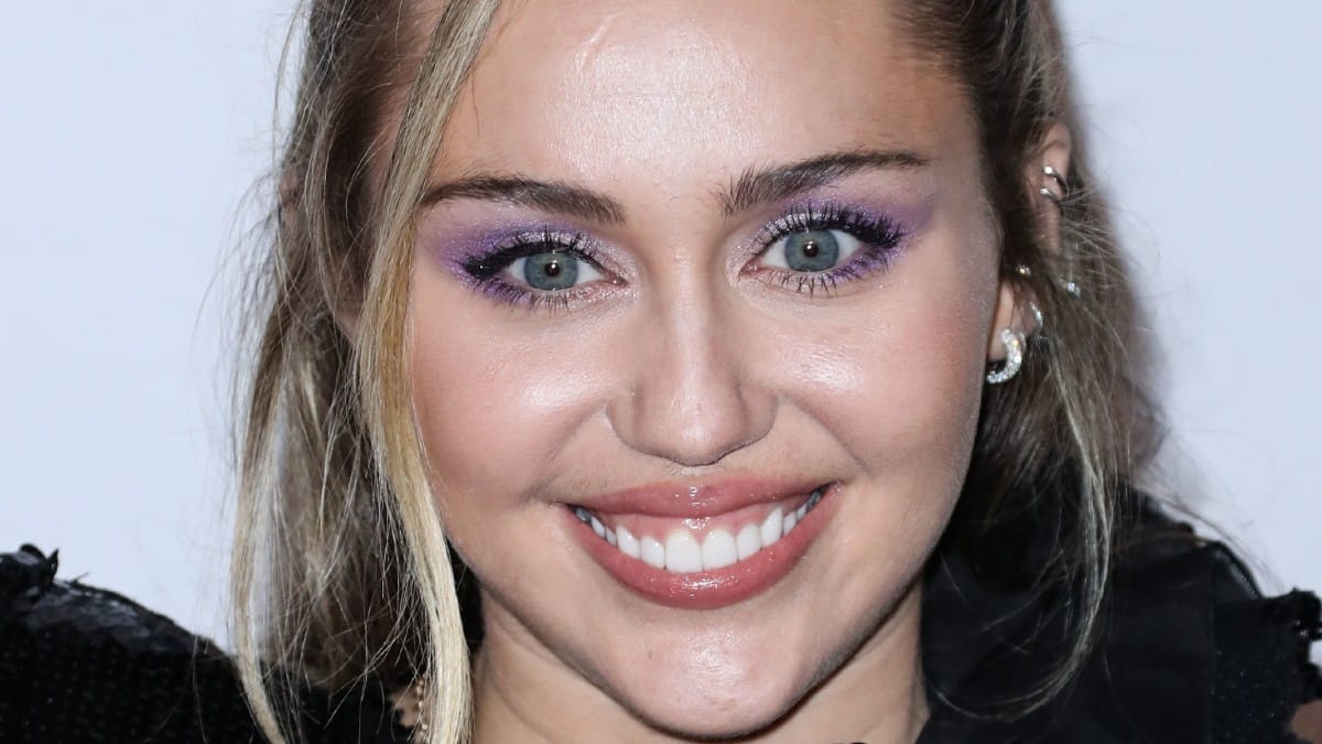 Miley Cyrus poses at an event.