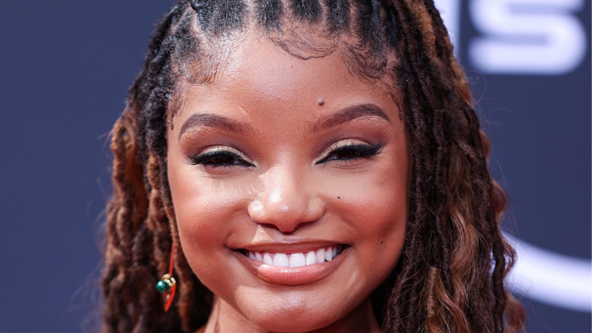 Halle Bailey relaxes on a swing in a pink bikini