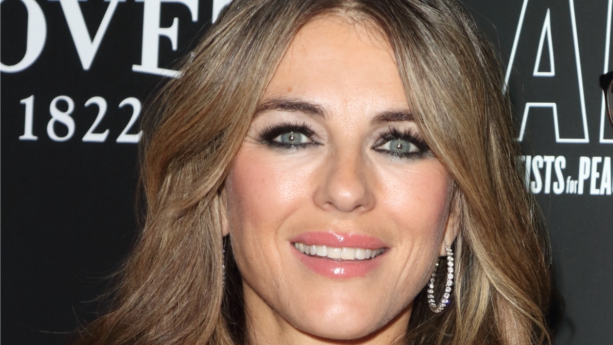Elizabeth Hurley fashions feather gown from her swimwear model