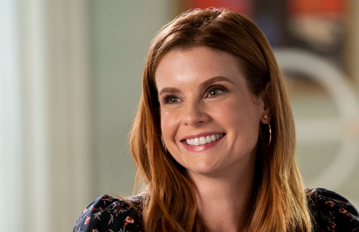 JoAnna Garcia Swisher as Maddie Townsend is looking off to her right, smiling, in the Netflix series, Sweet Magnolias