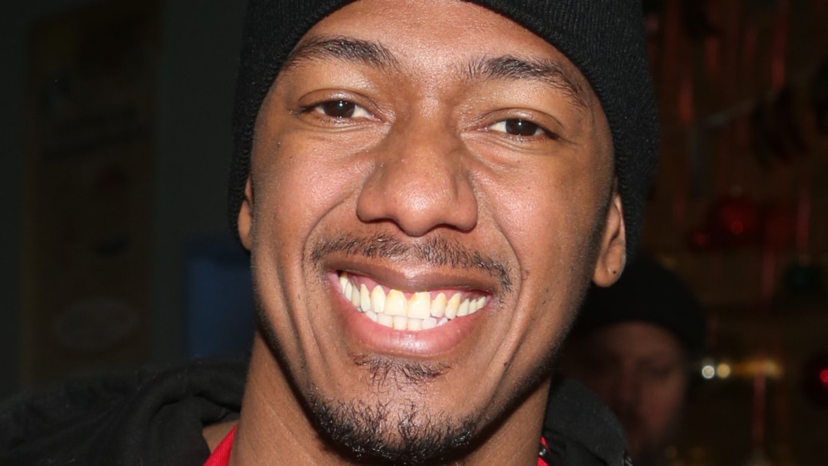 Nick Cannon smiles for a photo.
