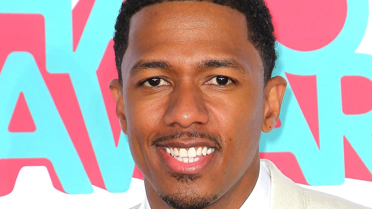A close up of Nick Cannon smiling
