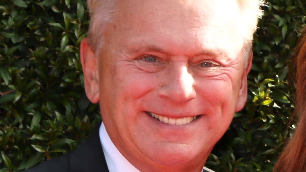 pat sajak poses for photos at an emmy awards event