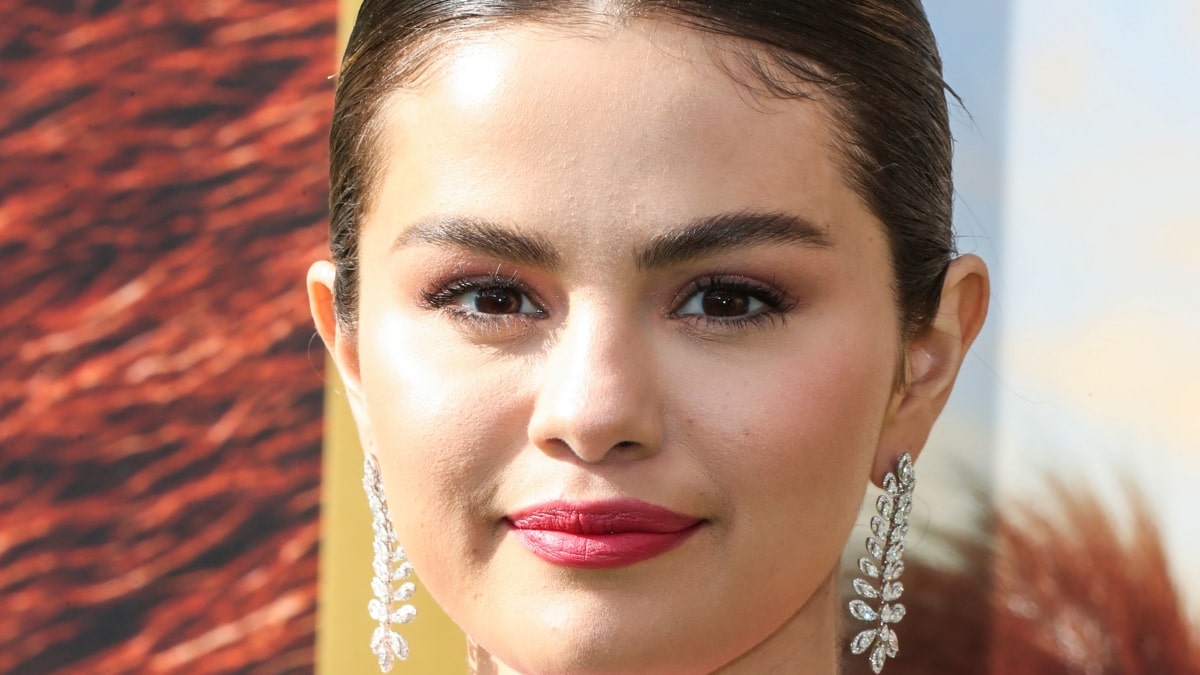 Selena Gomez smiles at a camera.